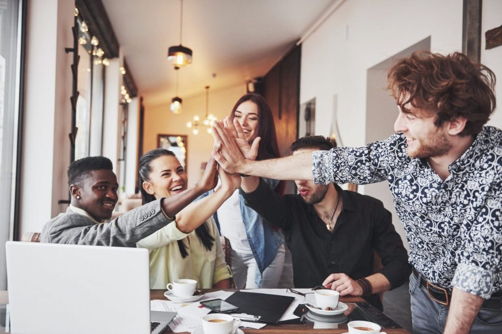 business-office-people-giving-high-fives-to-each-other-as-if-celebrating-success-e1605670011112